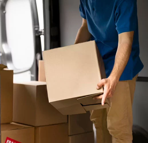 A man is packing the printing products into box and prepare for ship out.